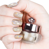 Nails featuring a champagne-gold holographic powder with warm burnt orange and brown undertones.